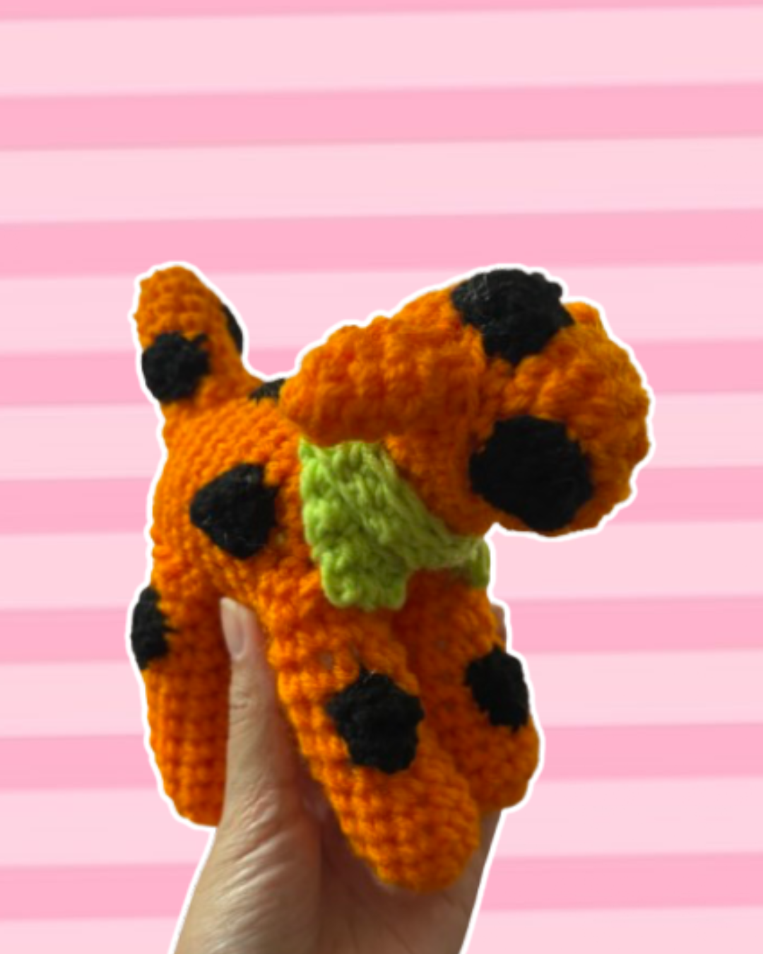 Orange and black polkadot puppy with green scarf